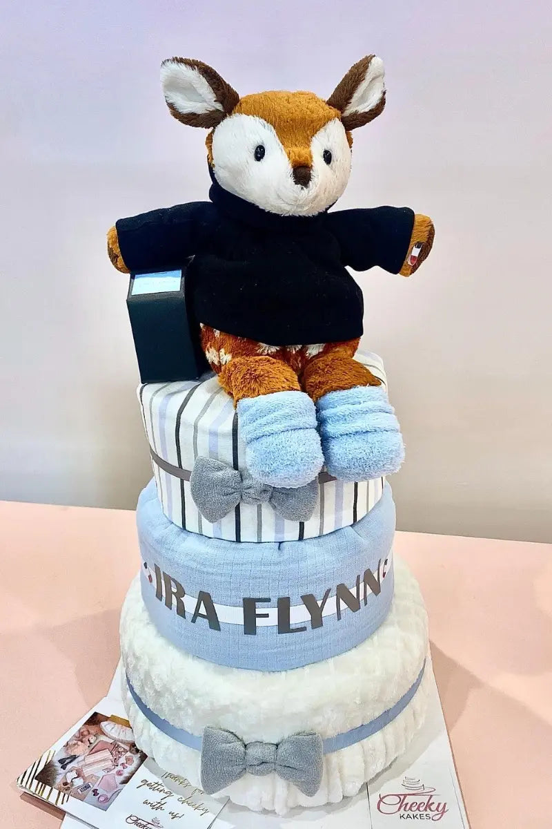 Custom diaper tower featuring a deer plush with blue and white accents, perfect for baby shower decorations.