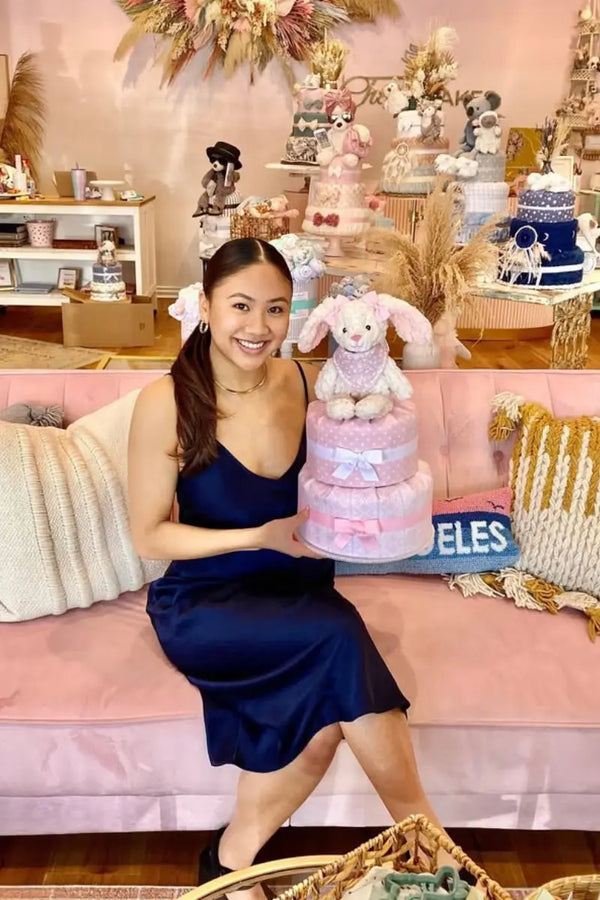 Interactive diaper cakes decorated with plush toys and creative themes, perfect for playful baby shower gifts.