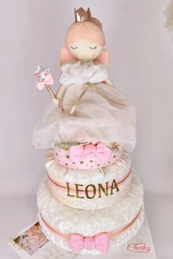 Present for baby shower featuring a princess-themed diaper cake with pink bows, gold accents, and a doll topper.